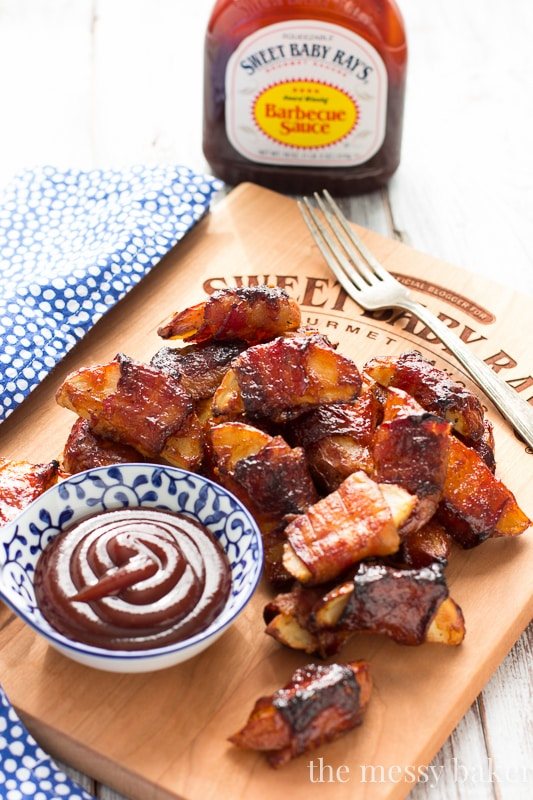 These crispy potato wedges wrapped in smoky bacon and glazed with barbecue sauce make the perfect appetizer for football, the holidays, and parties. | www.themessybakerblog.com