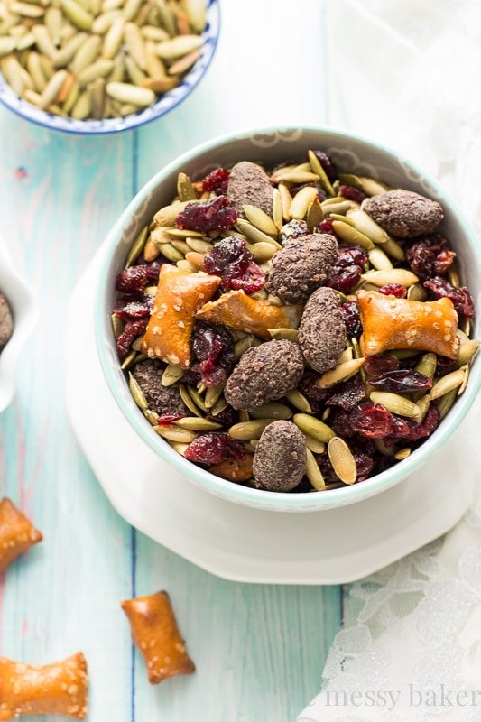 Easy Fall Trail Mix recipe made with pumpkin seeds, dried cranberries, peanut butter filled pretzels, and dark chocolate covered almonds | www.themessybakerblog.com