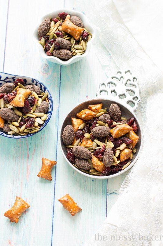 Easy Fall Trail Mix recipe made with pumpkin seeds, dried cranberries, peanut butter filled pretzels, and dark chocolate covered almonds | www.themessybakerblog.com