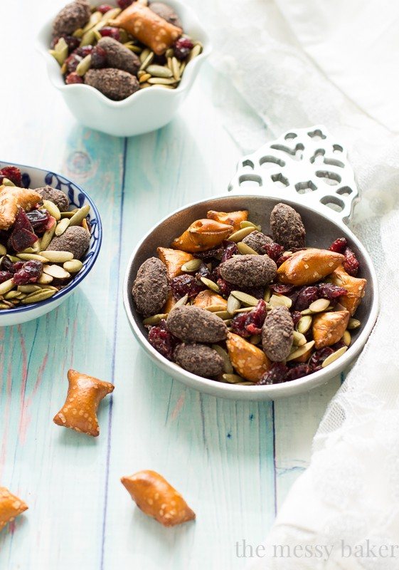 Easy Fall Trail Mix made with pumpkin seeds, dried cranberries, peanut butter filled pretzels, and dark chocolate covered almonds | www.themessybakerblog.com