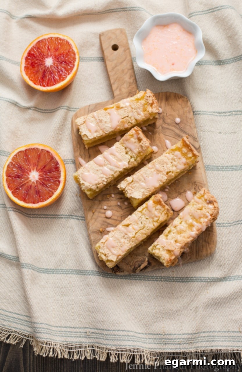 Blood Orange Bliss Bars, Vanilla Kissed 2 Thick, gooey Blood Orange Bars with a vibrant vanilla bean blood orange glaze, perfect for a citrus dessert