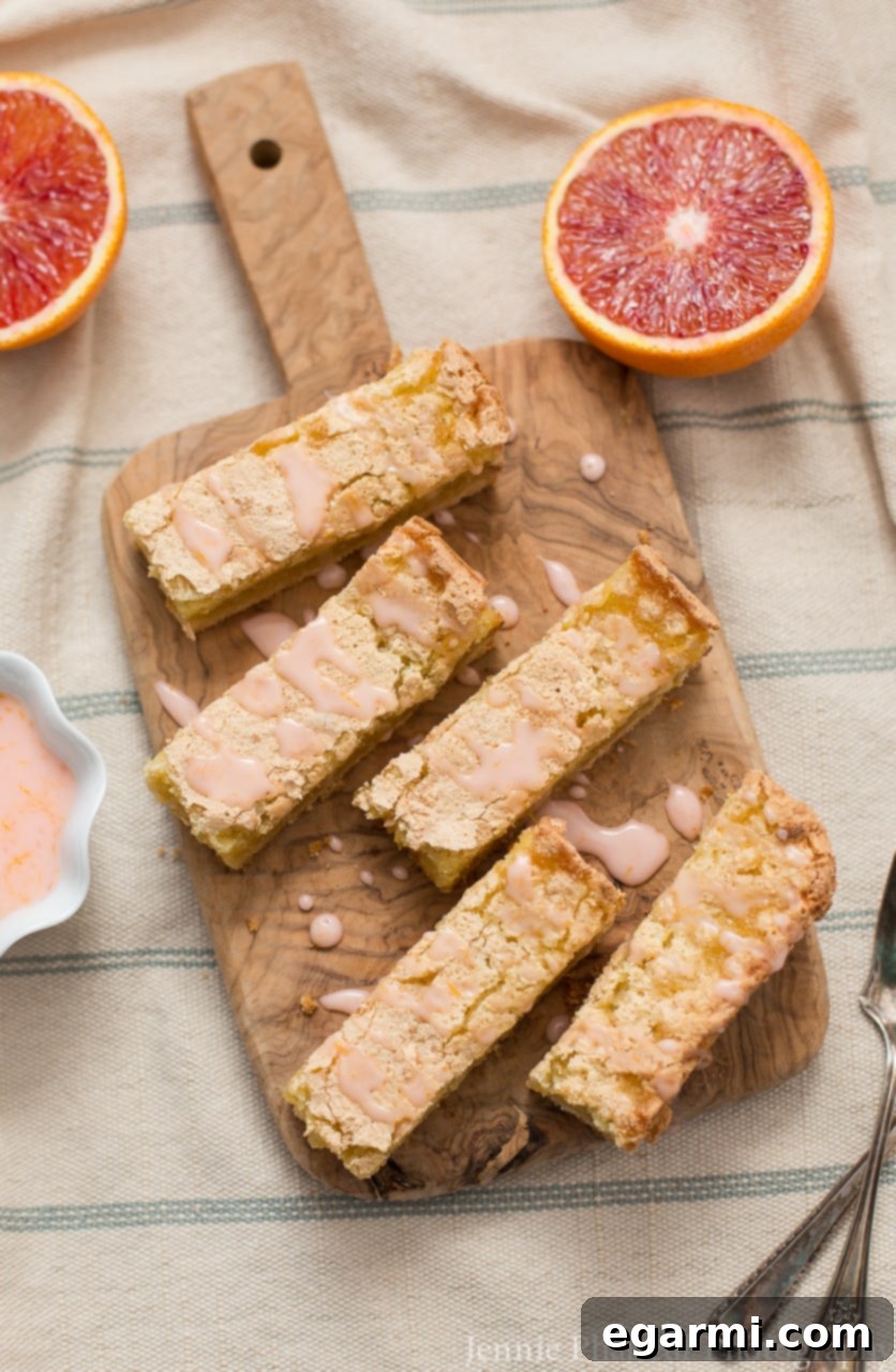 Blood Orange Bliss Bars, Vanilla Kissed 4 A tray of freshly baked Blood Orange Bars, showing their crackly top and gooey texture, ready for glazing