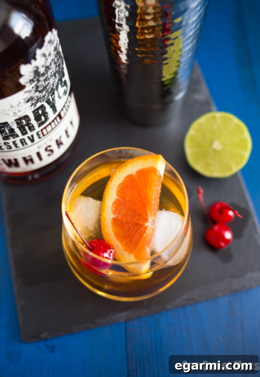 Citrus Trio Whiskey Zest 5 Triple Citrus Whiskey Sour Cocktail - Pouring the mixed drink into a glass with ice.
