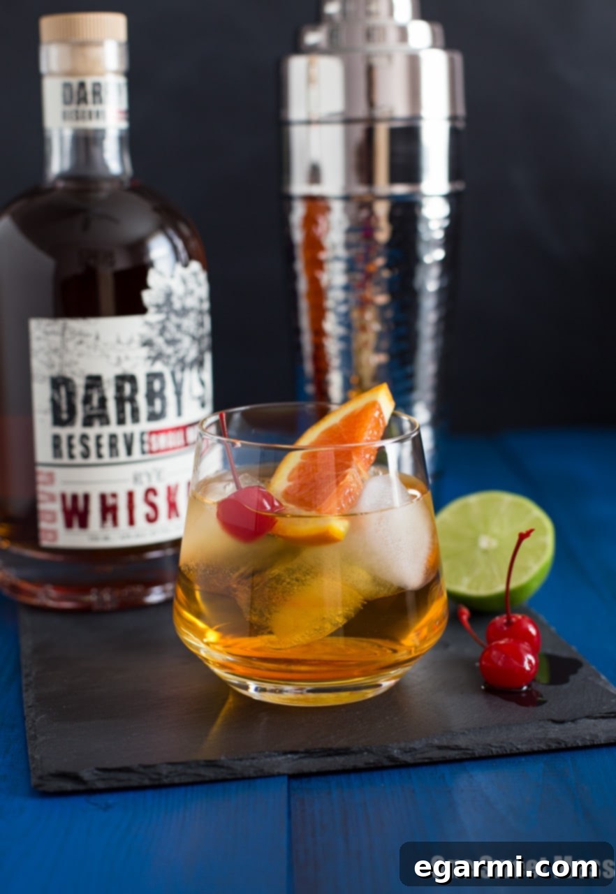 Citrus Trio Whiskey Zest 6 Triple Citrus Whiskey Sour Cocktail - Garnish of an orange slice and cherry on top.