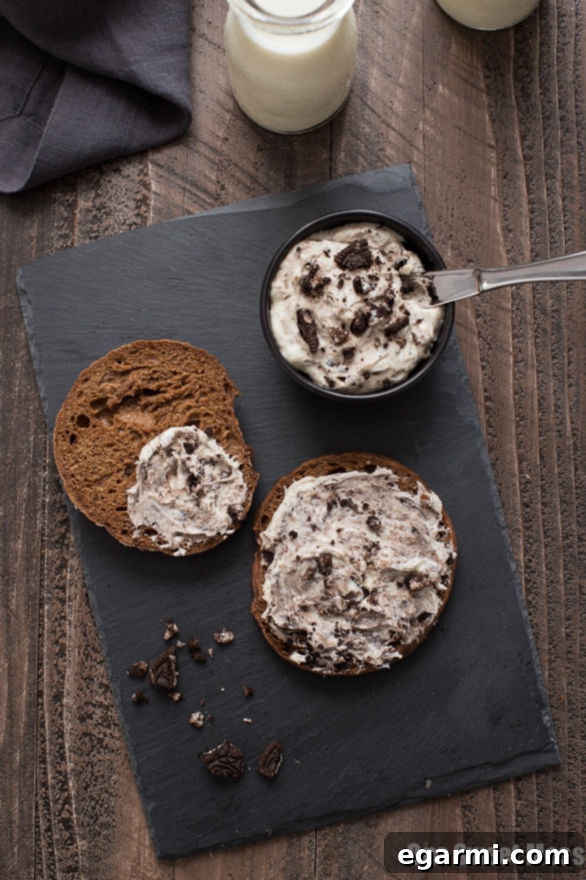 Hand holding a Chocolate Bagel with Cookies & Cream Whipped Cream Cheese