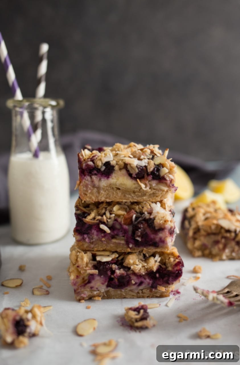 Close-up of a single Blueberry Coconut Cheesecake Bar with crispy topping