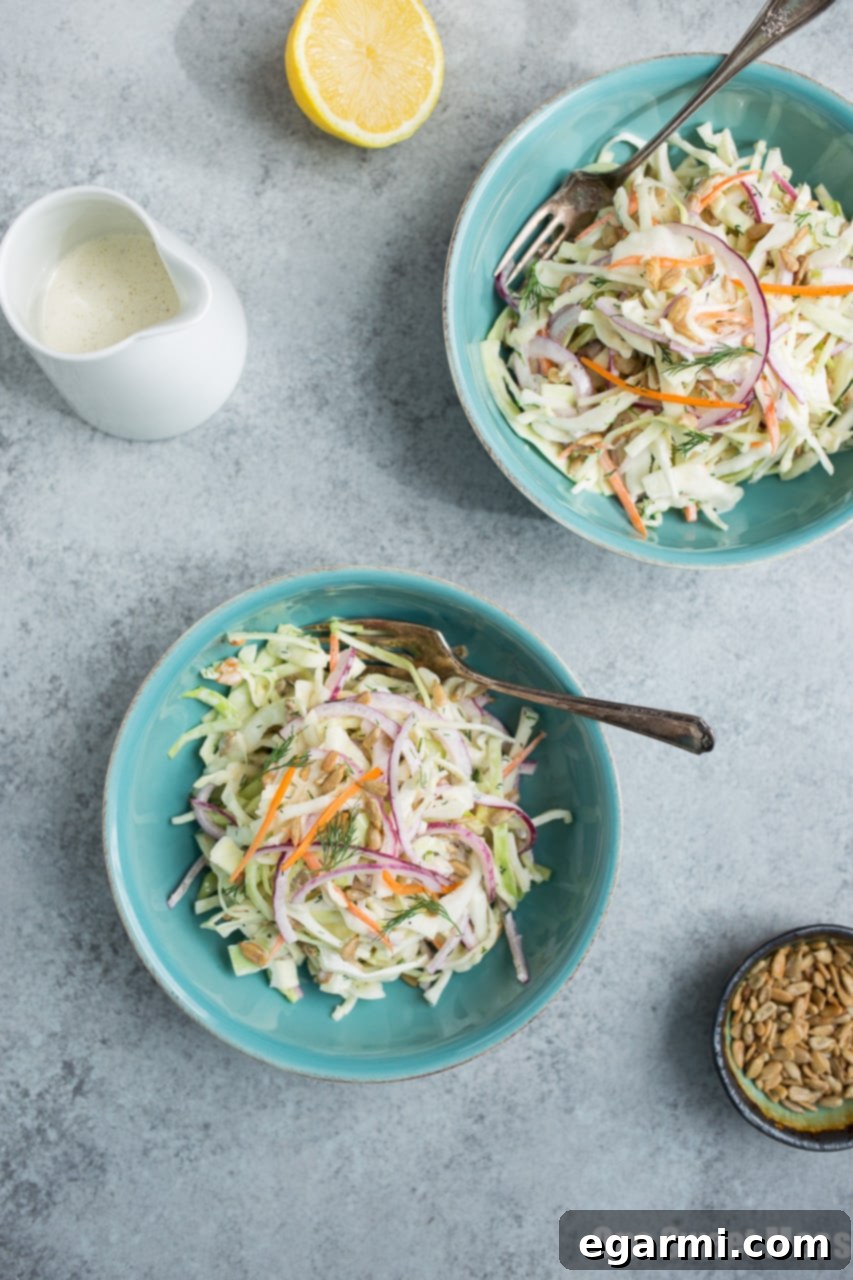 Ingredients for Lemon Dill Coleslaw laid out, including fresh dill and lemons