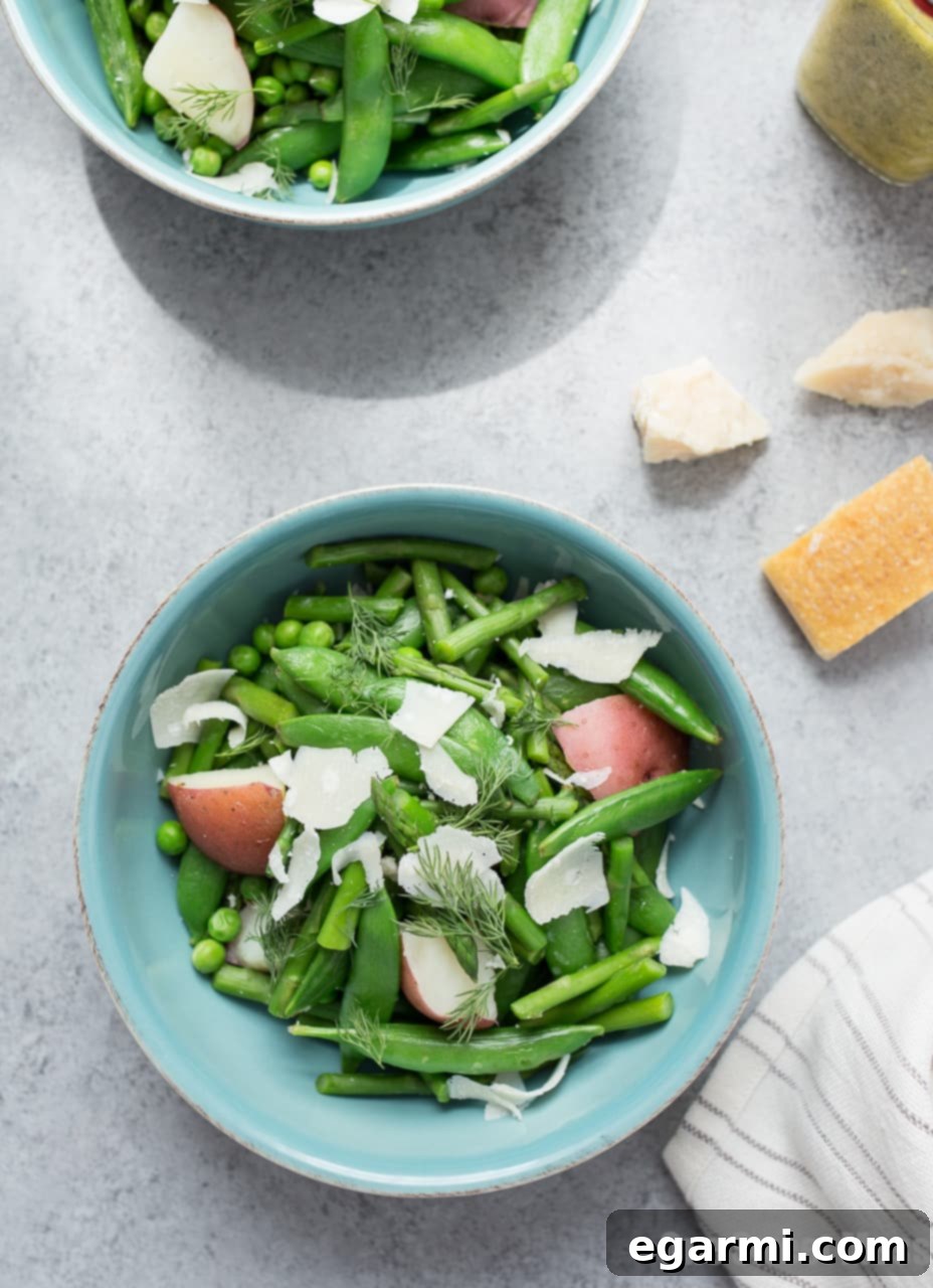 Spring Pea and Asparagus Salad served in a large bowl, drizzled with Lemon Dill Vinaigrette.