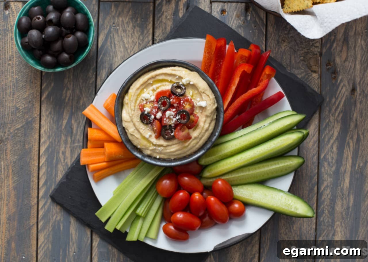 Casual Greek Hummus Platter with various vegetables and dippers