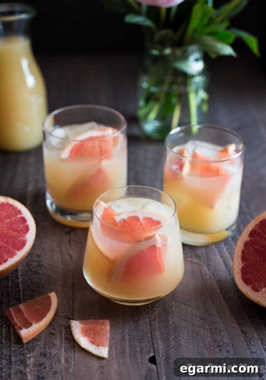 Close-up of a Bourbon Grapefruit Cocktail garnished with a grapefruit wedge