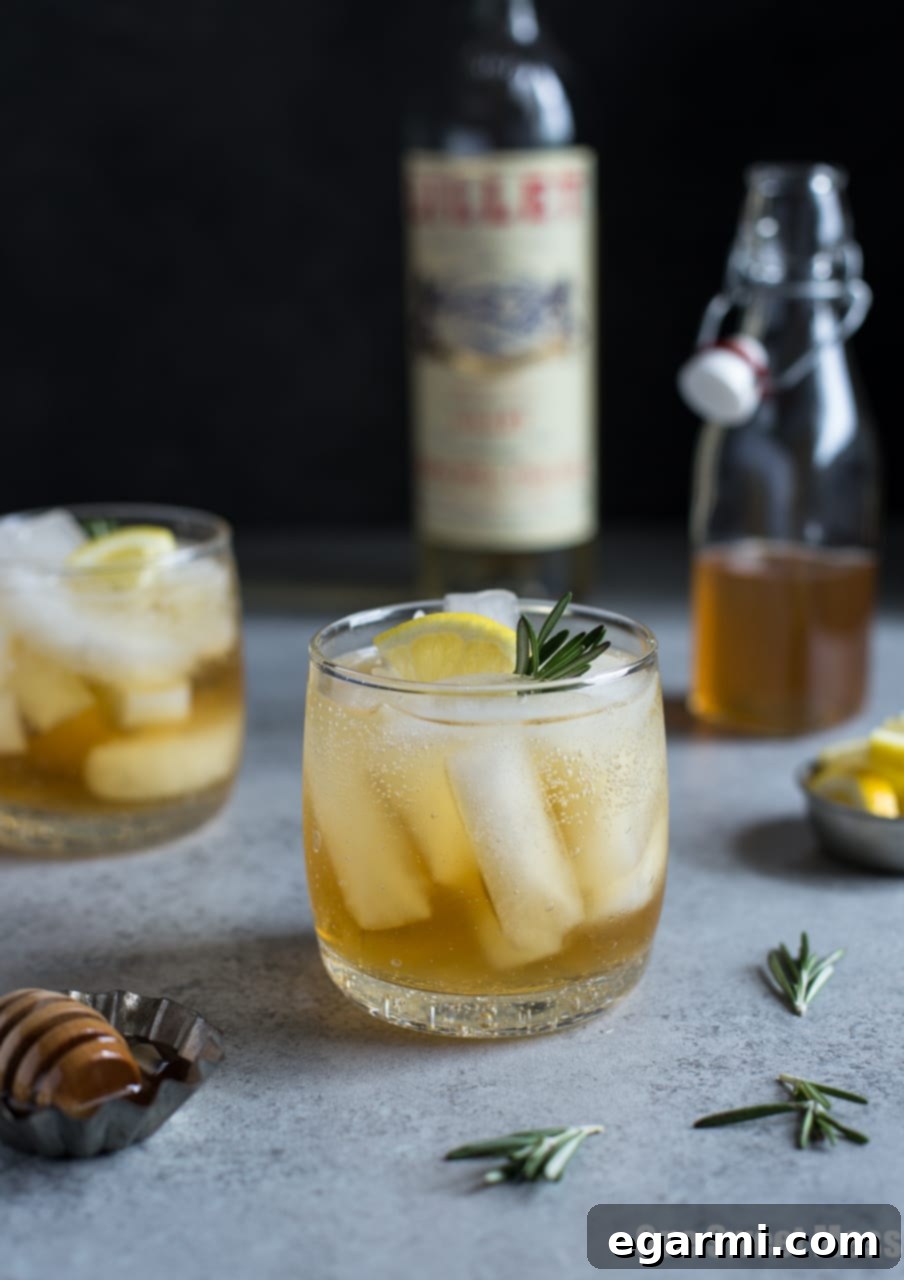 Rosemary Honey Lillet Spritz 5 Close-up of a Honey Rosemary Lillet Spritzer with rosemary garnish