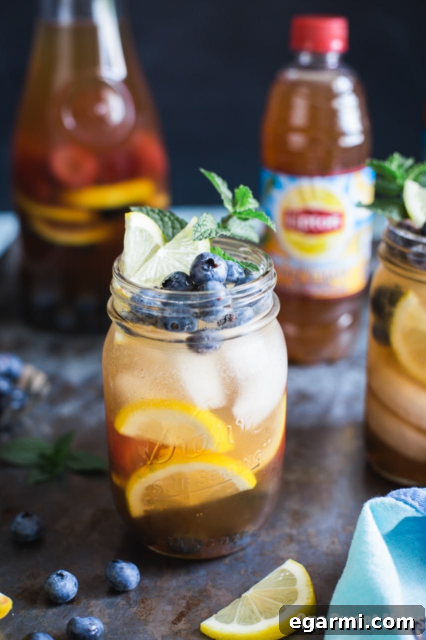 Close-up of Blueberry Sweet Tea Lemonade Sangria in a glass with lemon and blueberries