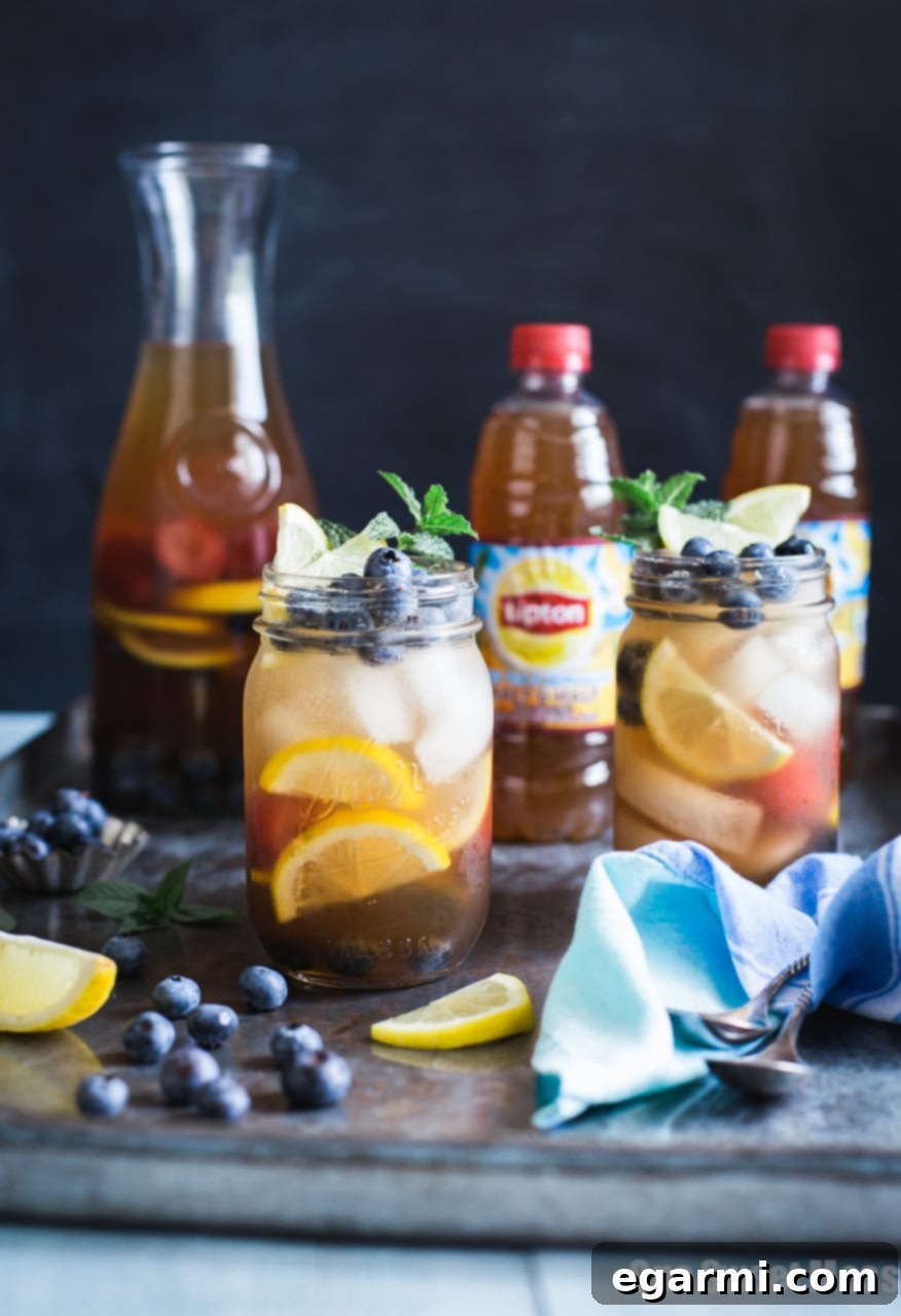Pouring Blueberry Sweet Tea Lemonade Sangria from a pitcher into a glass