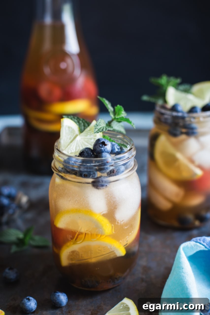 Close-up of Blueberry Sweet Tea Lemonade Sangria in a glass, garnished with fresh fruit