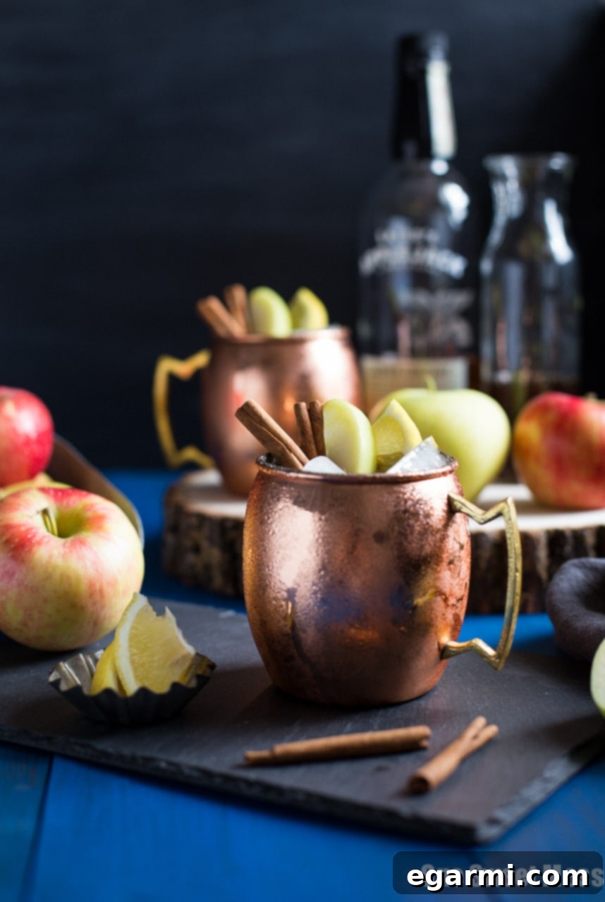 Top-down view of an Apple Pie Mule with ingredients scattered around, showcasing its autumnal appeal.