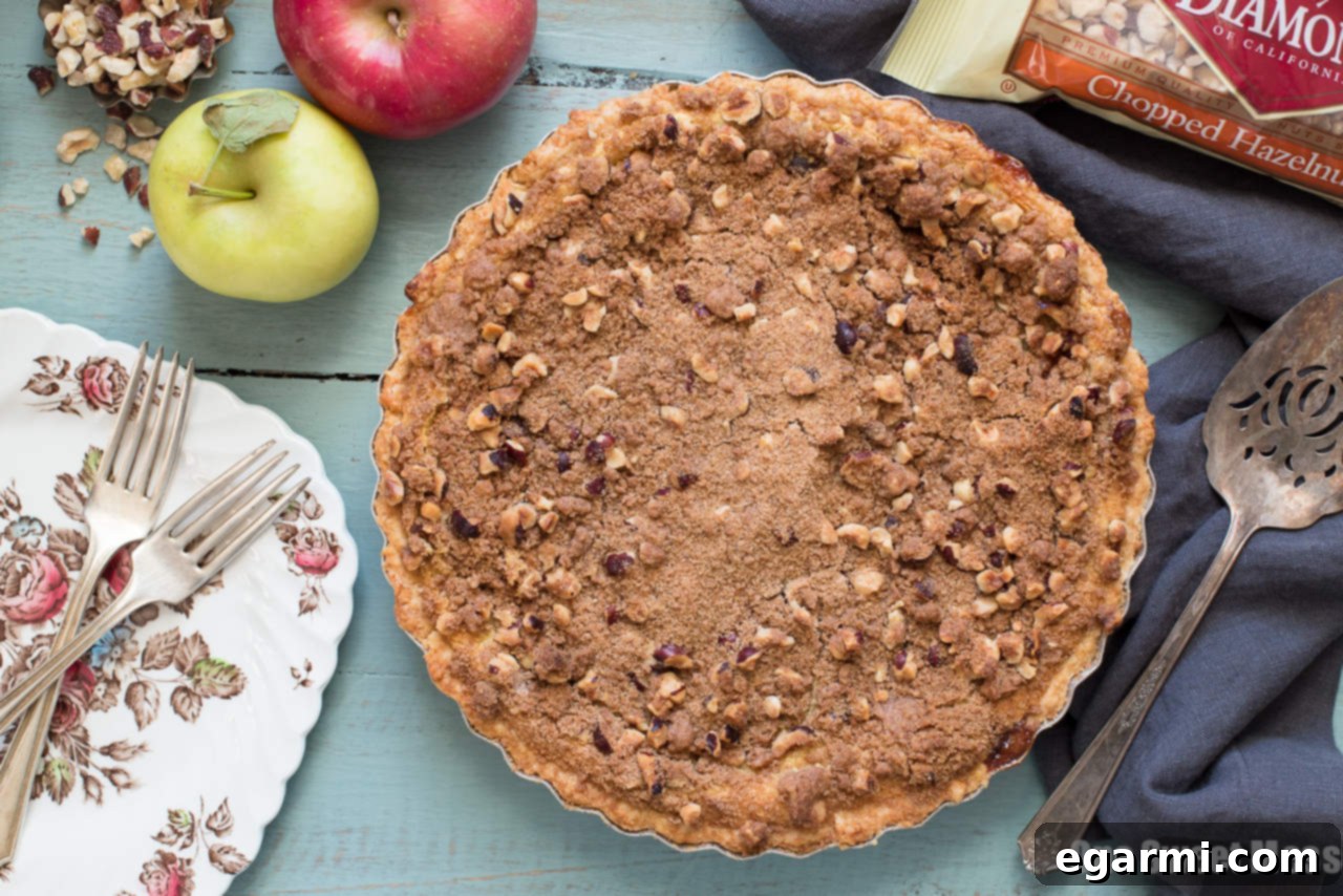 Rich Apple Custard Pie with golden Hazelnut Streusel and creamy Whiskey Cinnamon Whipped Cream, perfect for holidays