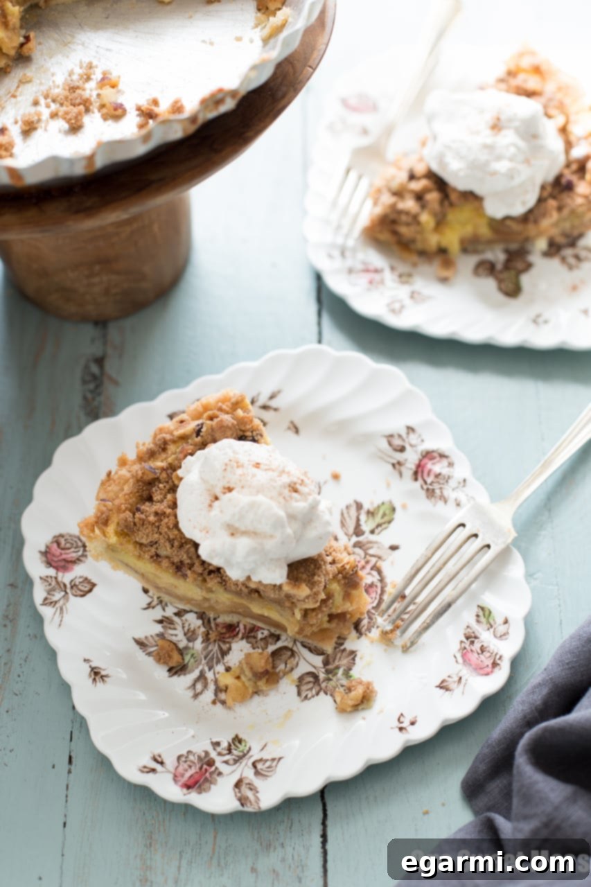 Close-up of baked Apple Custard Pie, showing the layers of apple, custard, and streusel