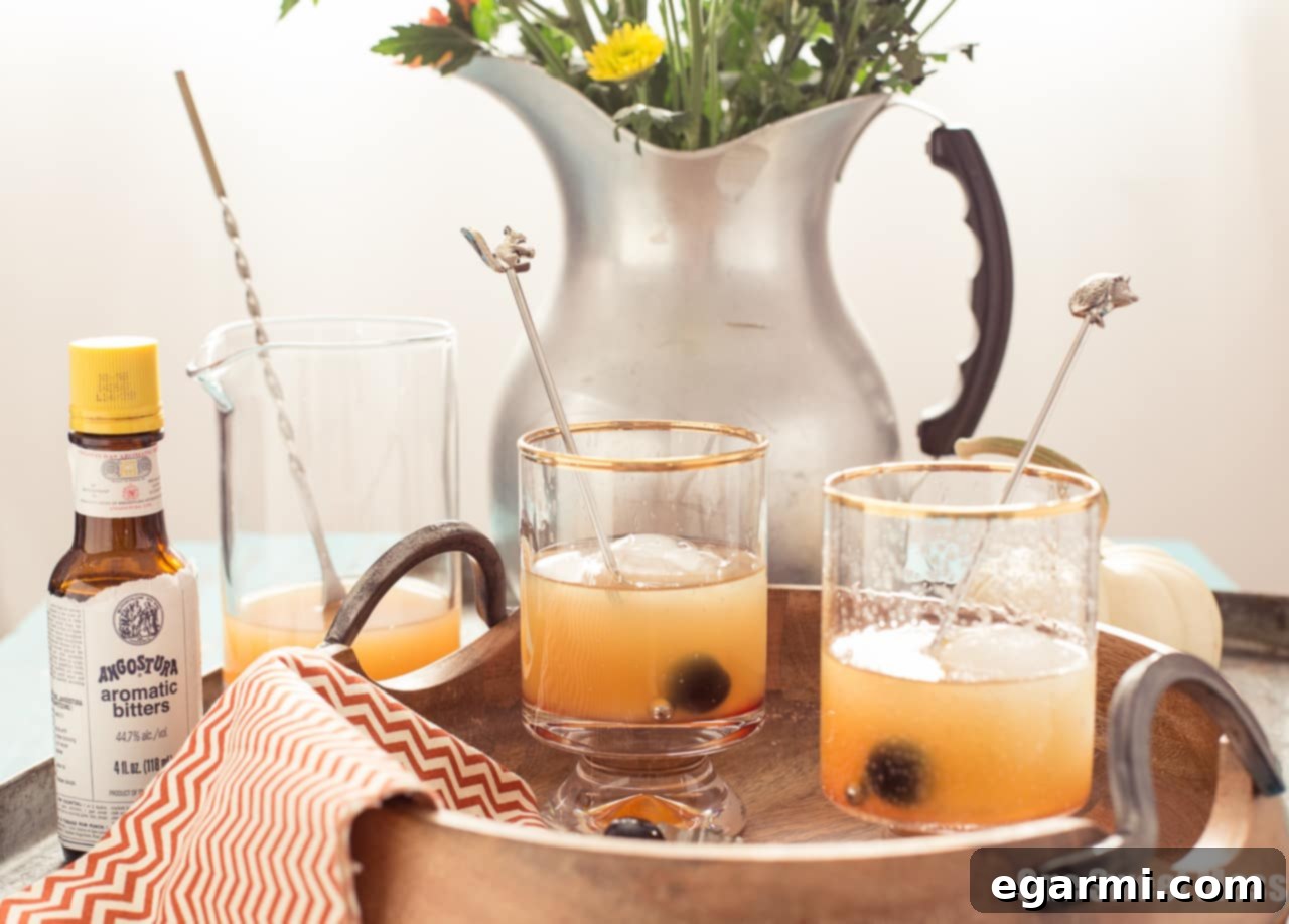 Pumpkin Spice Rum Old Fashioned Cocktail Garnished with Orange Peel