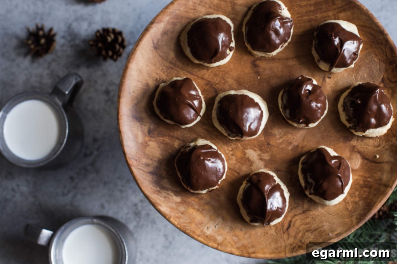 Buttery Hazelnut Sandies Dipped in Chocolate 4 A selection of Chocolate Dipped Hazelnut Sandies, some dipped, some not, on a cooling rack.