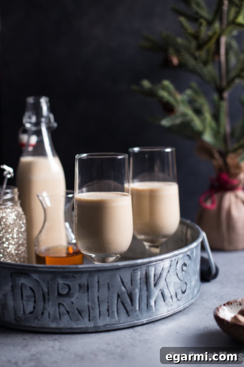 Harvest Pumpkin Bourbon Eggnog 2 Rich and creamy Pumpkin Spice Bourbon Eggnog in a festive glass, garnished with cinnamon stick and star anise