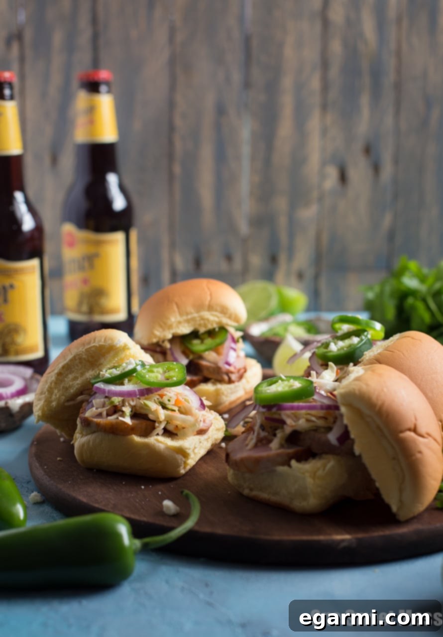 Finished Chipotle Pork Sliders arranged on a platter, ready to serve at a party