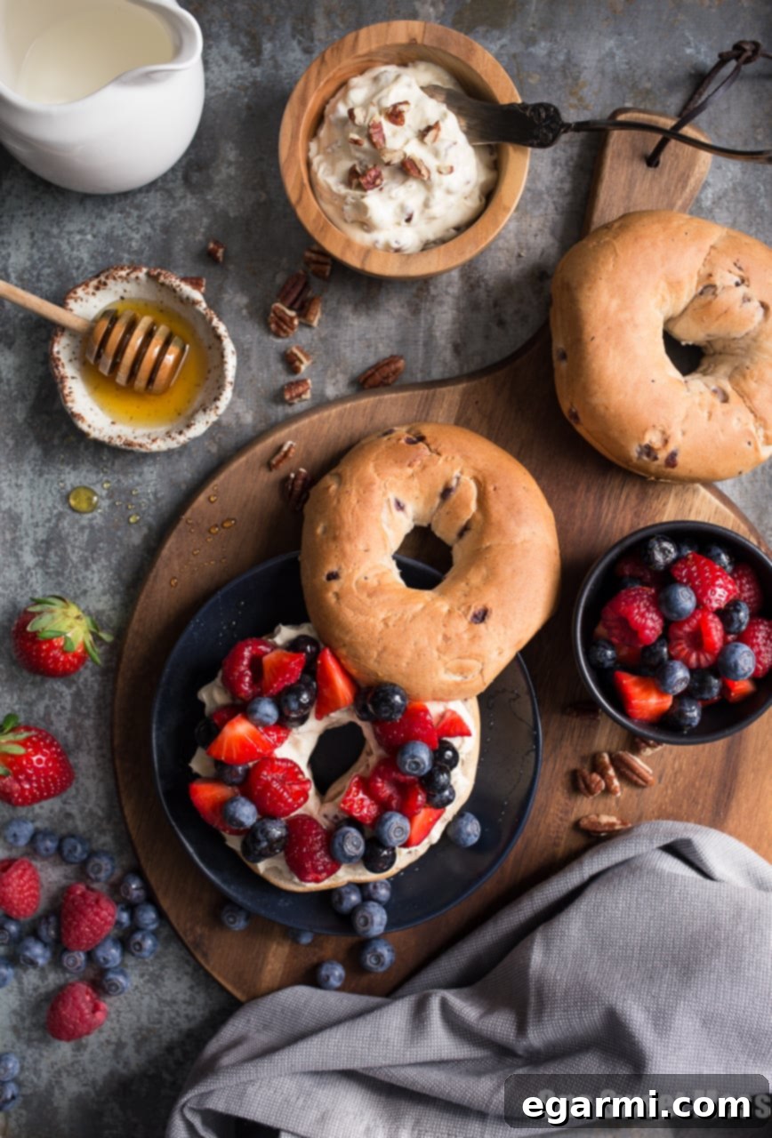 Honey Pecan Whipped Cream Cheese with Honeyed Fruit Salad on a bagel, ready to be enjoyed