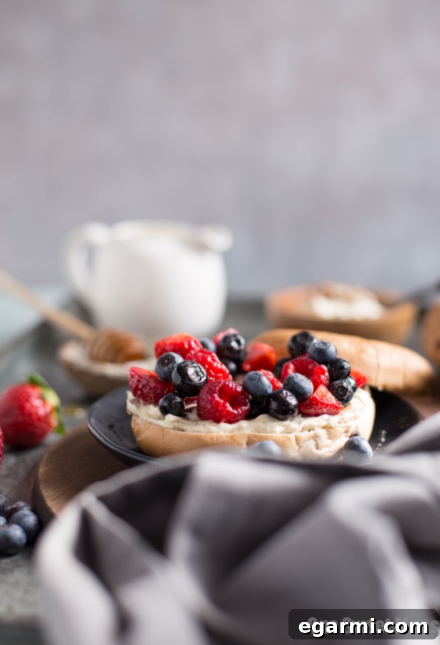 Two halves of a bagel spread with Honey Pecan Whipped Cream Cheese and topped with fresh fruit