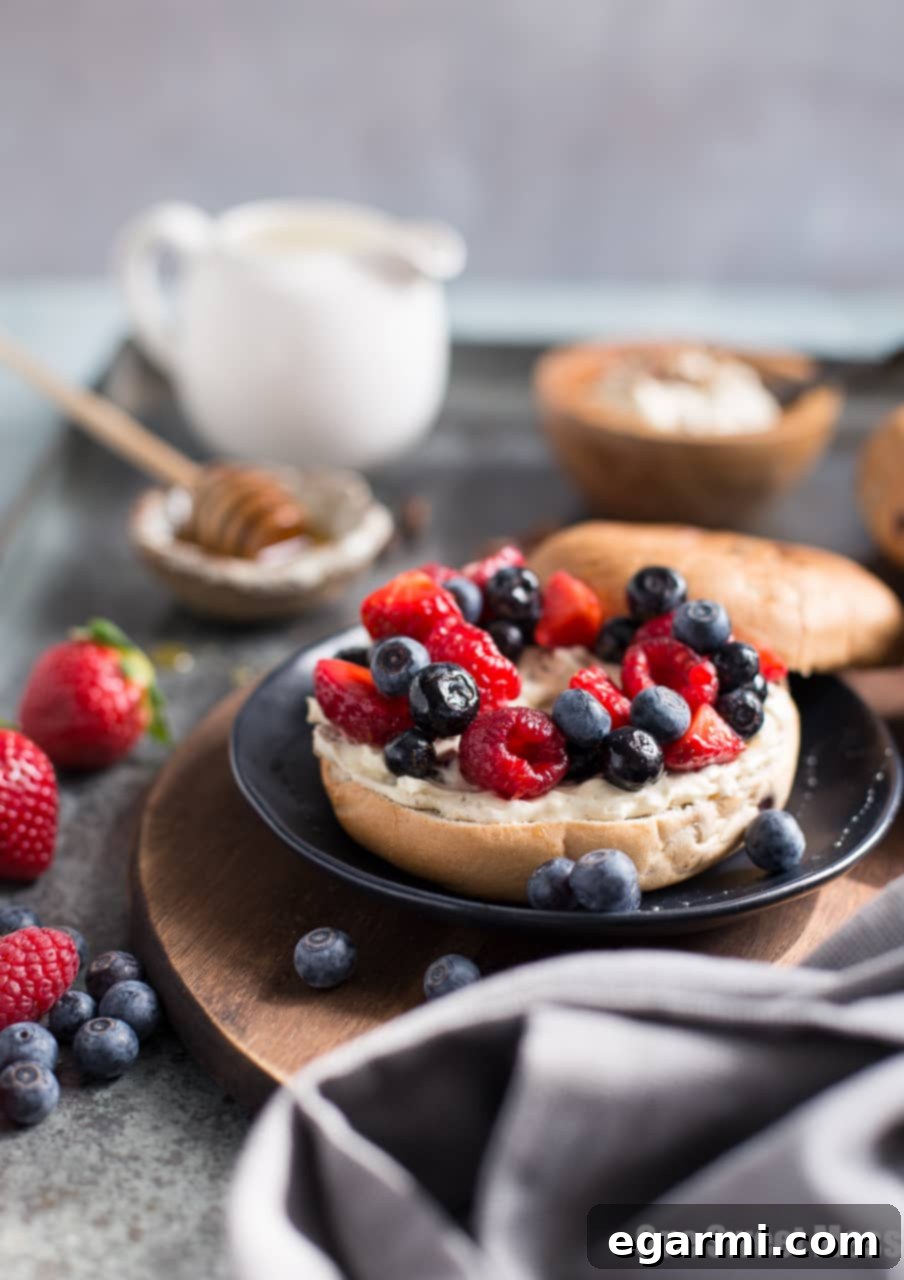 A bowl of vibrant Honeyed Fruit Salad with fresh berries, orange zest, and honey