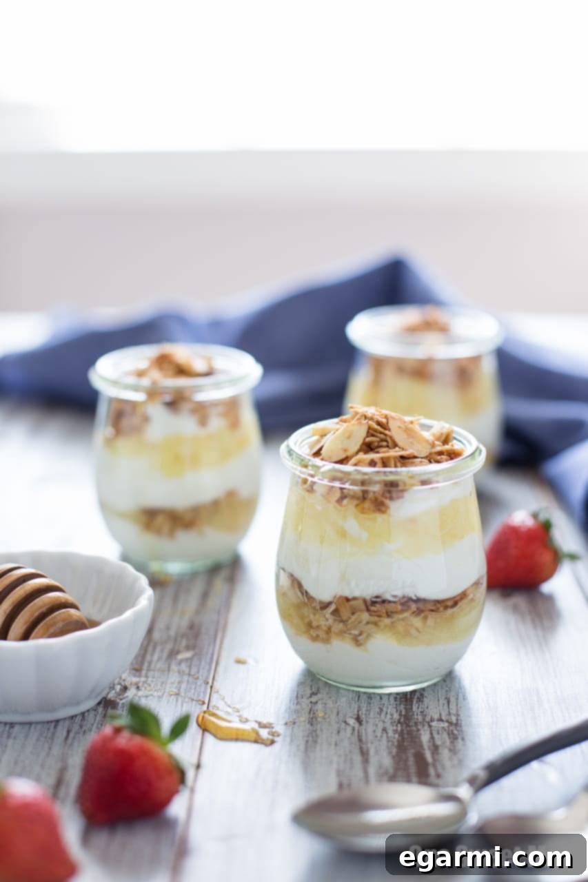 Pina Colada Yogurt and Honey Parfait - Layers of Greek yogurt, granola, pineapple, and honey