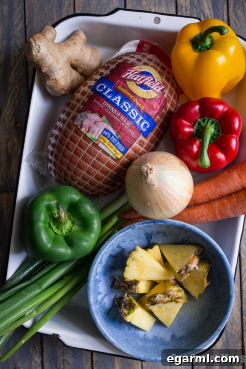 Ingredients for Pineapple Ham Fried Rice laid out on a cutting board