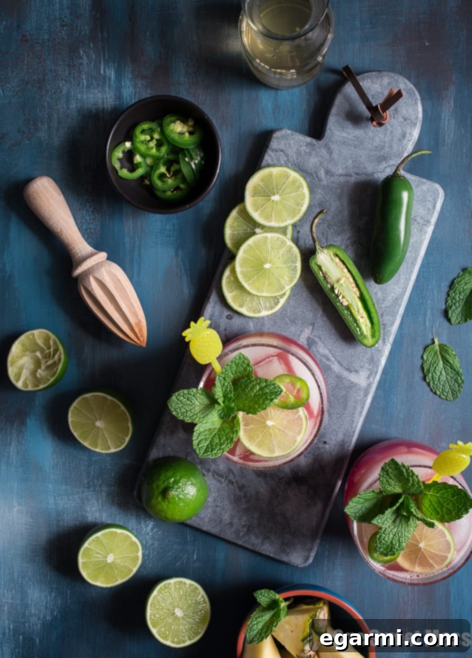 Close-up of a Cranberry Pineapple Jalapeño Margarita with garnishes