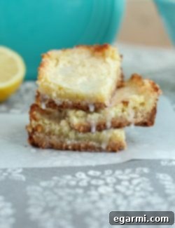 A single perfectly cut lemon bar showing its layers