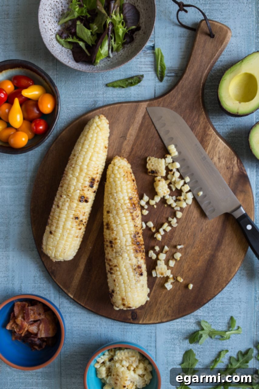 Prepared ingredients for BLT Salad with Grilled Corn and Avocado Ranch Dressing in bowls