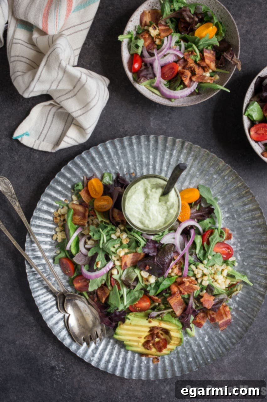 Avocado Ranch Dressing being drizzled over BLT Salad