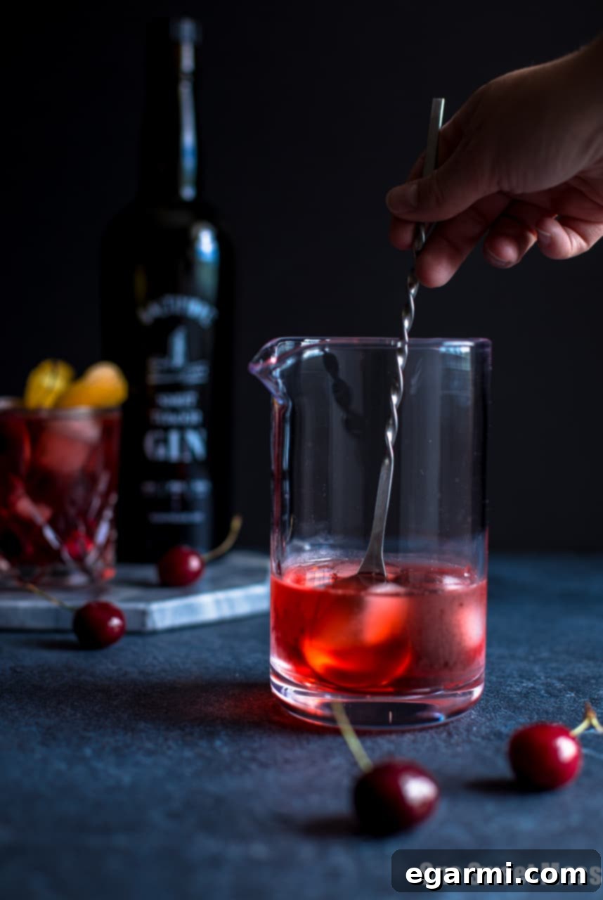 Cherry Negroni ingredients being prepared for a fresh summer cocktail.
