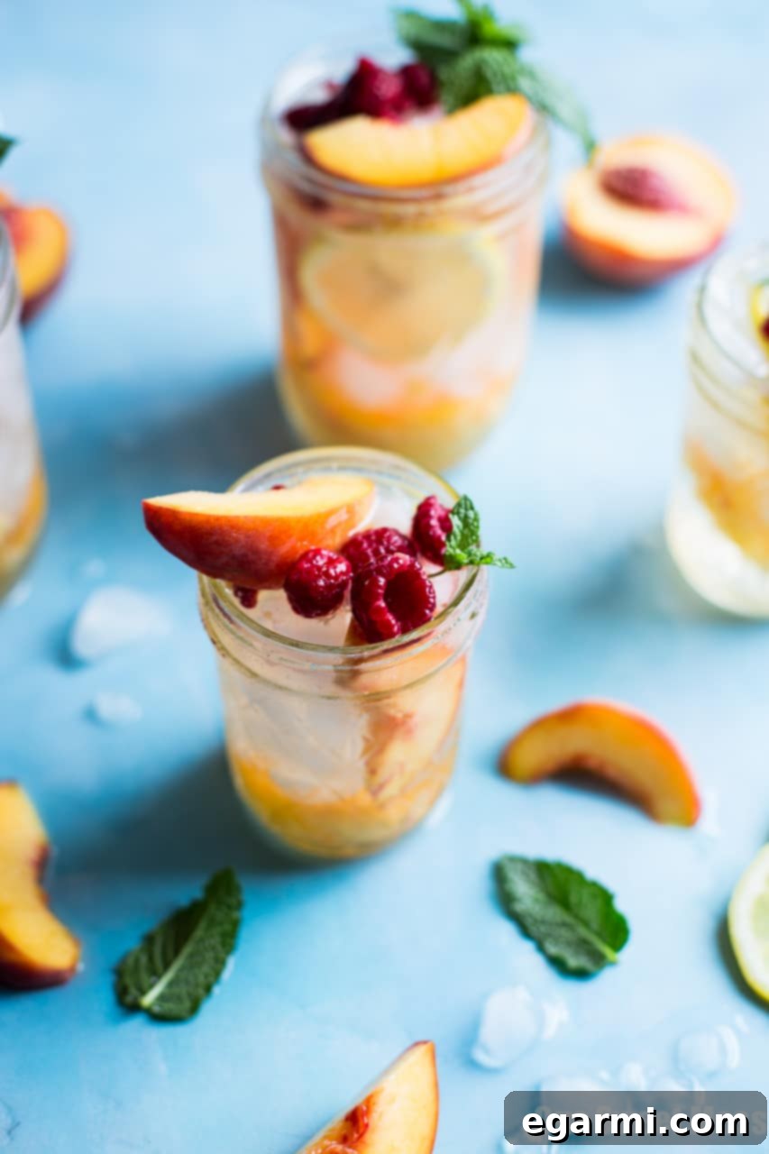 Close-up of a refreshing Fresh Peach Crush Cocktail in a glass with crushed ice, perfect for a hot day