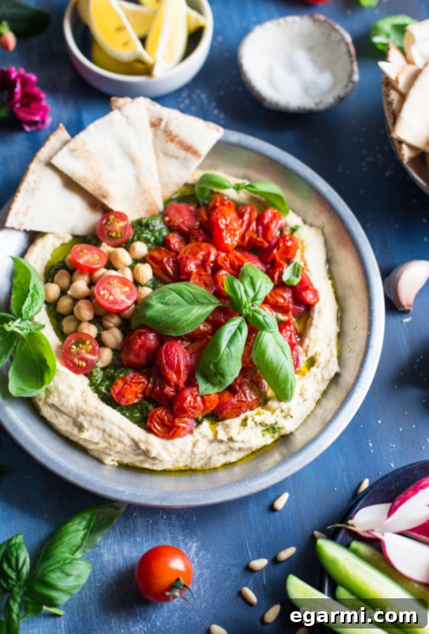 Savory Pesto Hummus with Bursting Roasted Cherry Tomatoes 3 Close-up of Homemade Pesto Hummus topped with Burst Roasted Tomatoes