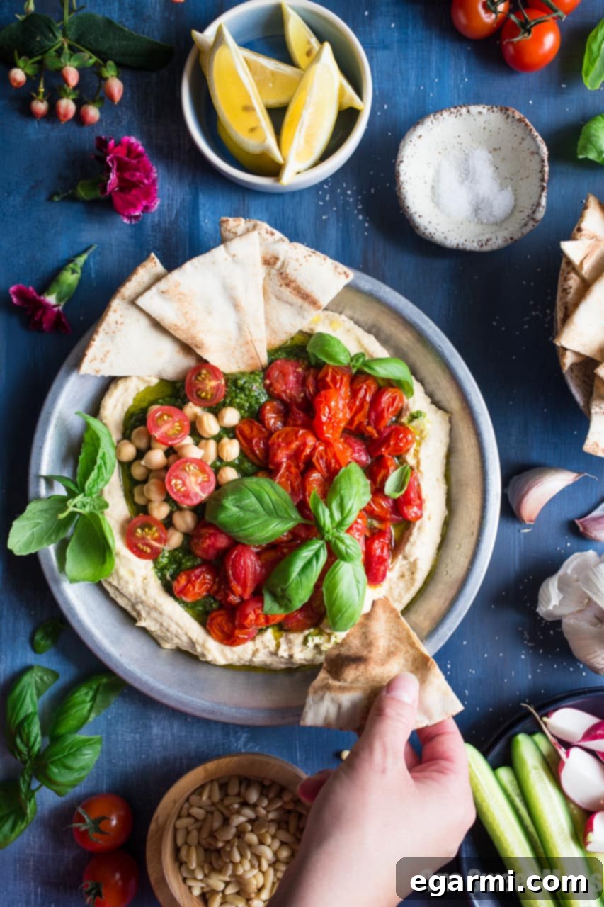 Savory Pesto Hummus with Bursting Roasted Cherry Tomatoes 4 Fresh Pesto Hummus served with Toasted Pita and Colorful Roasted Tomatoes