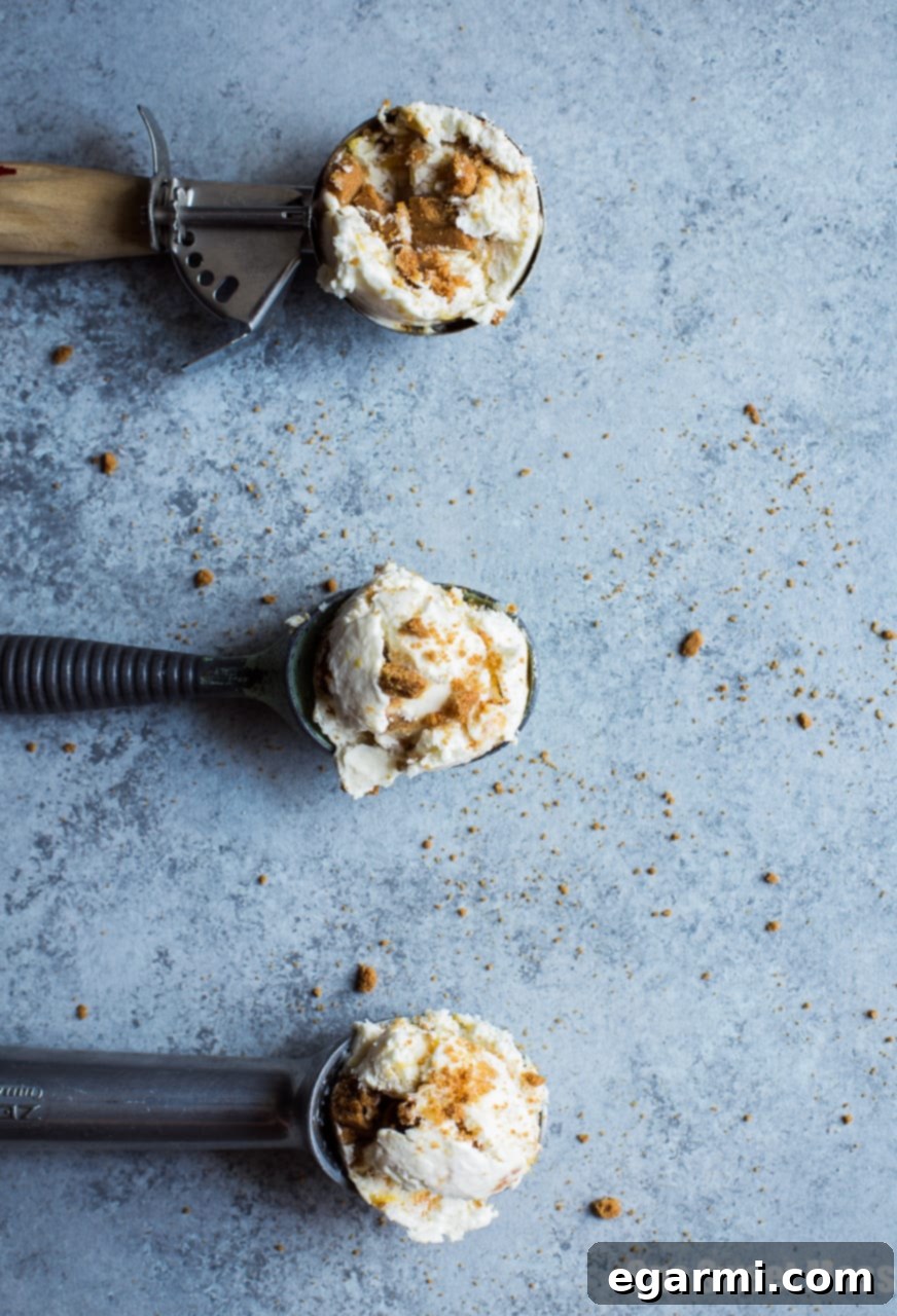 Close-up of No-Churn Peach Cobbler Ice Cream showing smooth texture and peach swirls.
