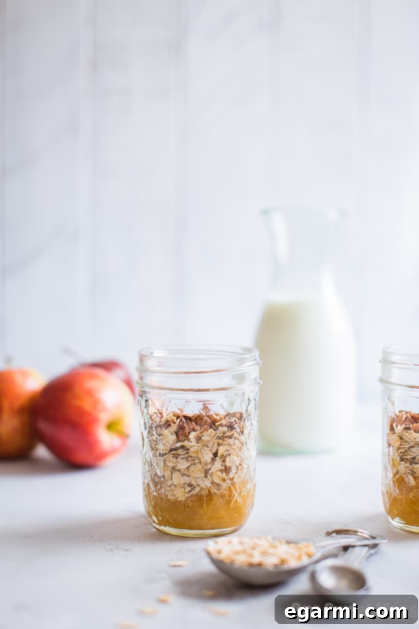 Close-up of Apple Pie Overnight Oatmeal layered in a jar, showcasing the rich apple compote and oats