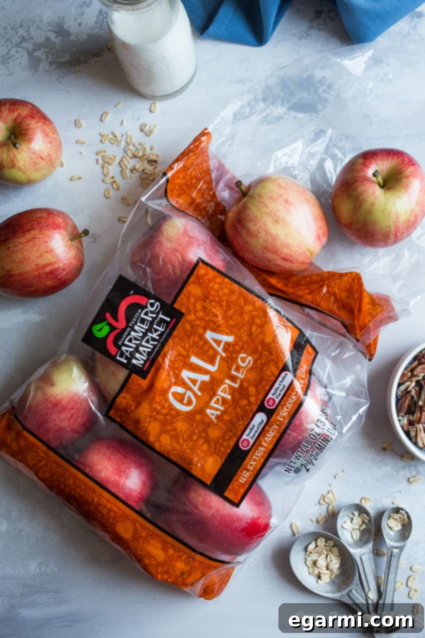 Preparing the apple compote for Apple Pie Overnight Oatmeal, showing fresh apples and cinnamon sticks