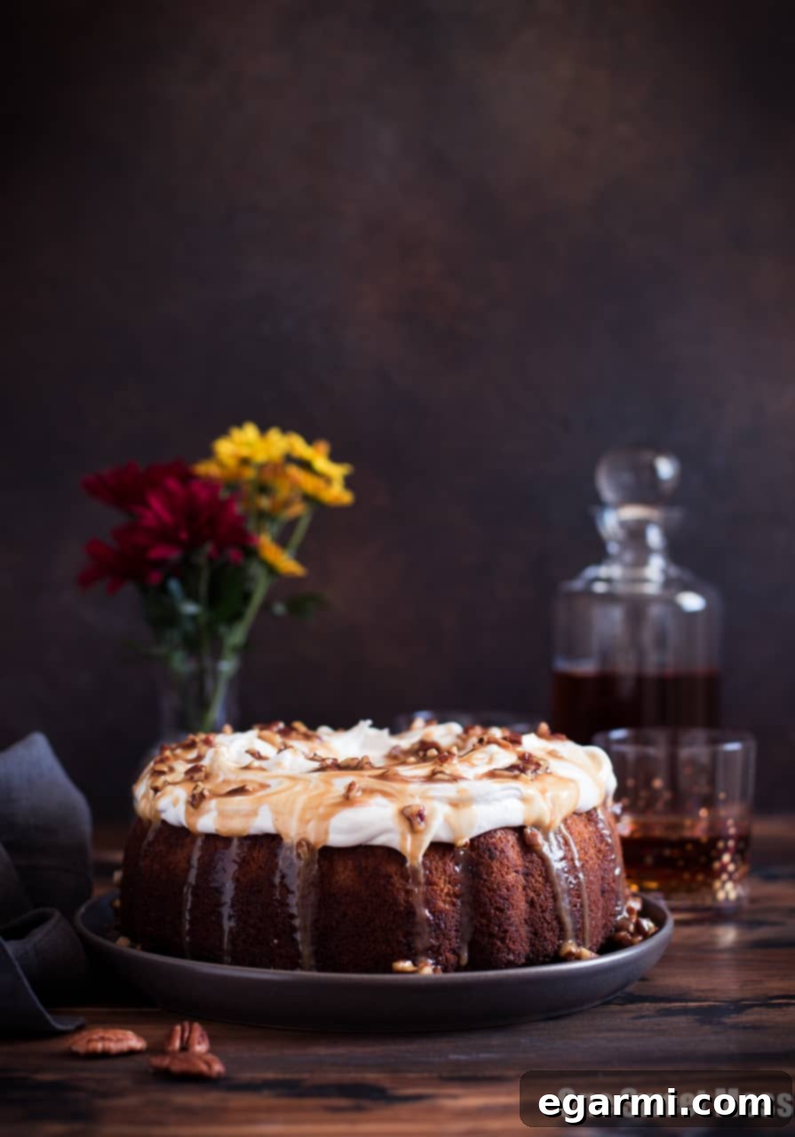 Sweet Potato Bundt Cake with Marshmallow Frosting and Bourbon Pecan Caramel Drizzle, a perfect holiday dessert