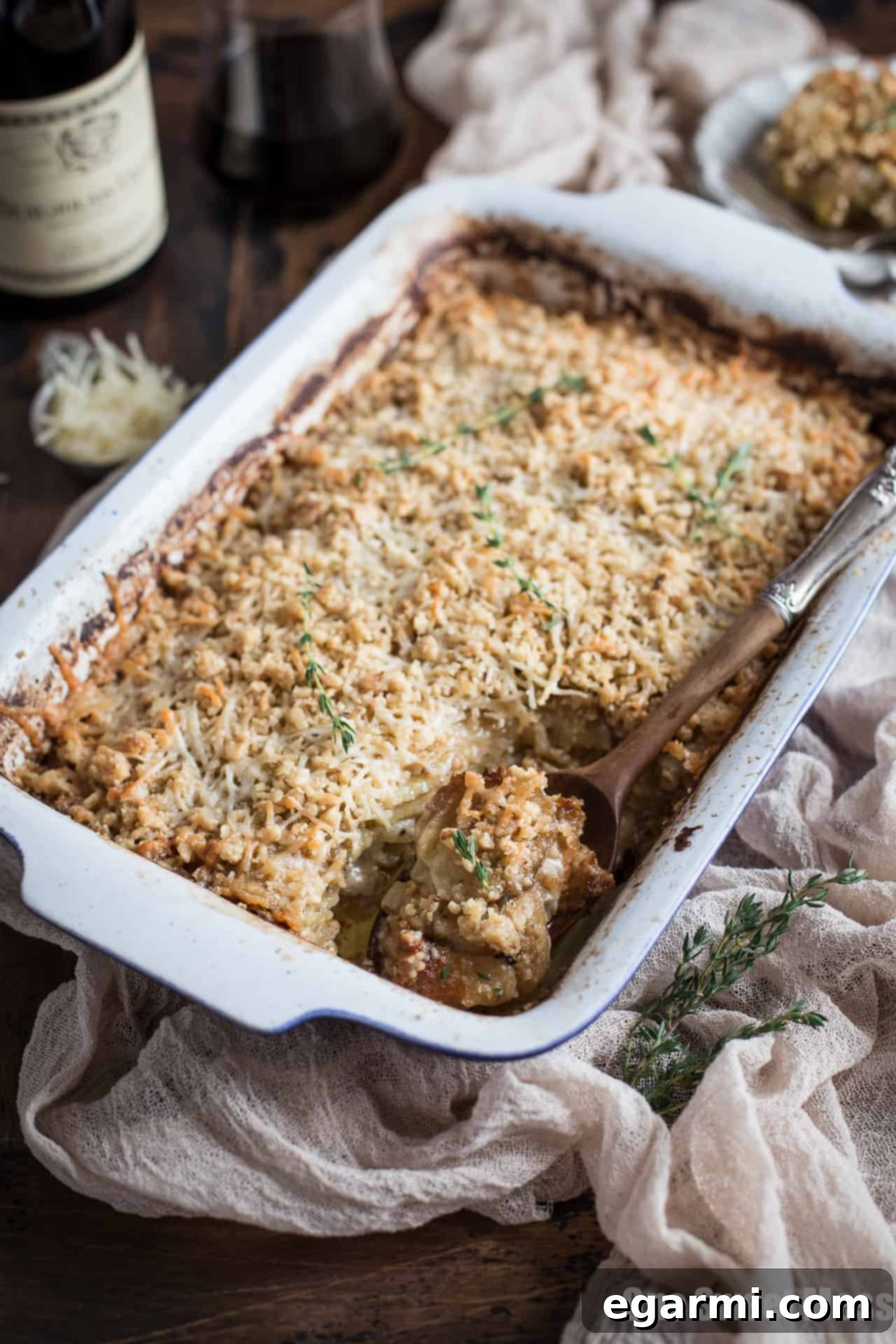 Golden brown Potato Leek Gratin, featuring layers of creamy potato, savory leeks, and a generous coating of cheese, baked to perfection.