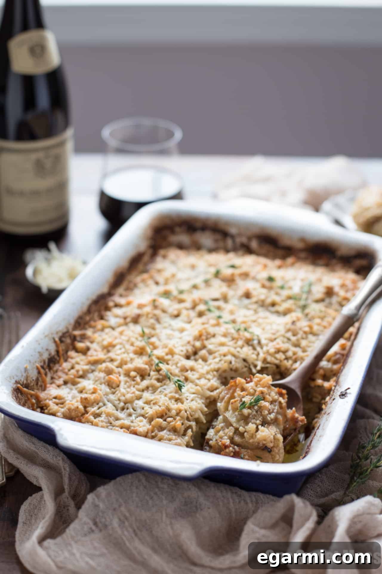 Scoops of Potato Leek Gratin on a serving plate, showing the layers and crispy topping, ideal for a comforting meal.