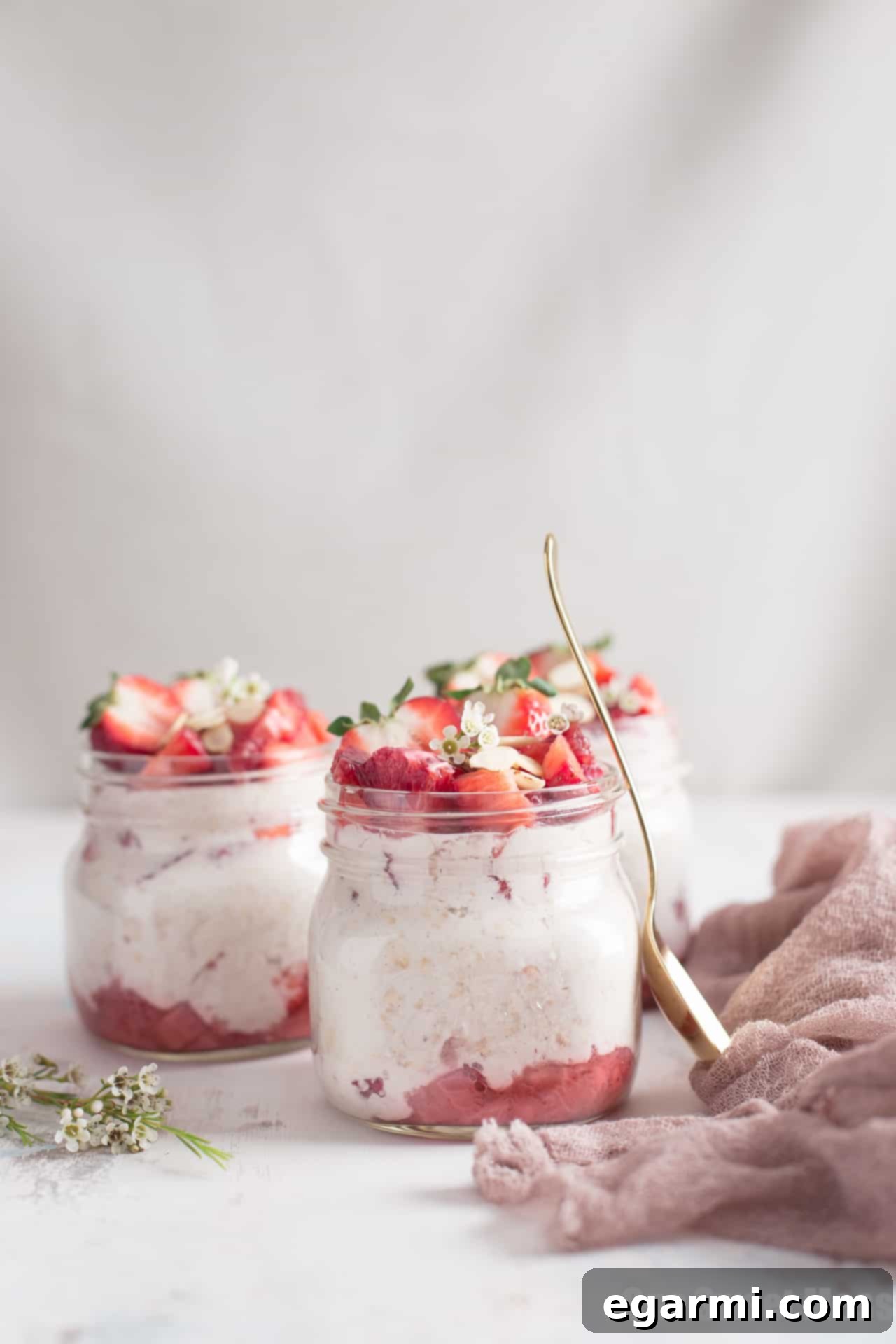 Overhead view of Strawberries and Cream Overnight Oatmeal in a jar, showcasing layers of fruit and oats.