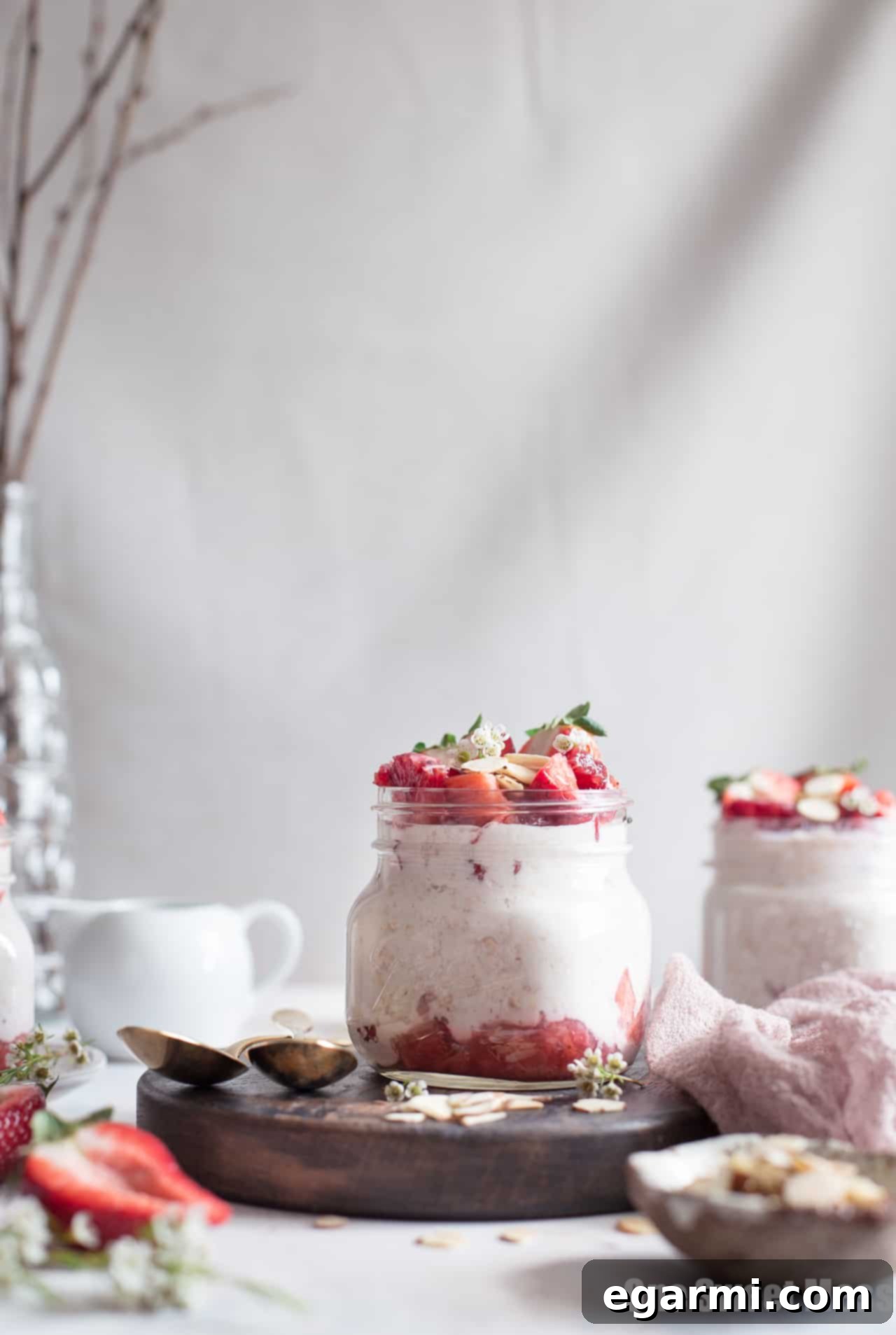 Close-up of fresh strawberries being cooked into a compote, a key component for the overnight oats.