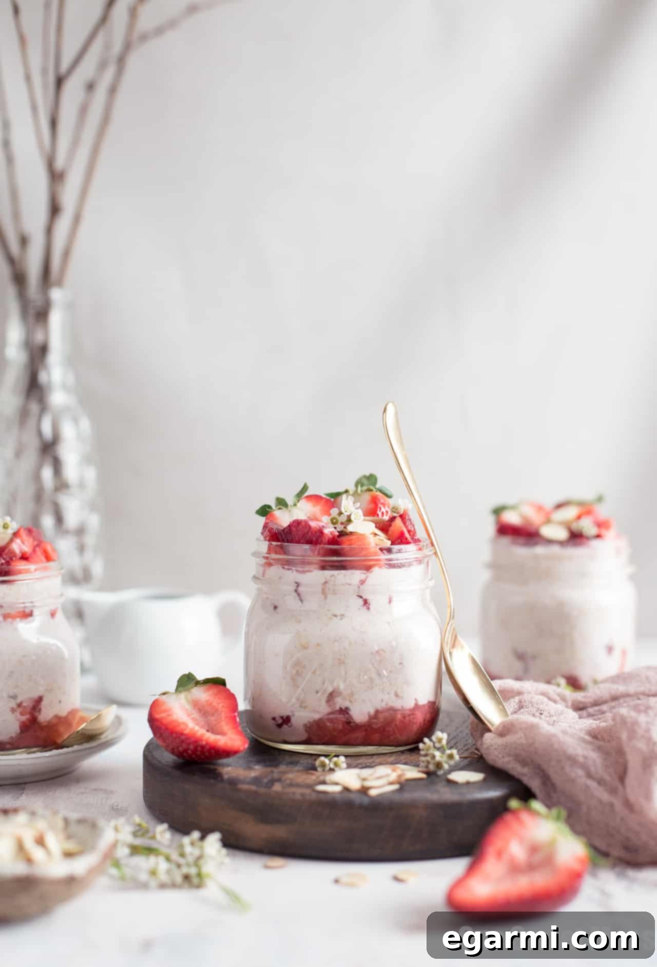 A close-up of the creamy texture of Strawberries and Cream Overnight Oatmeal with visible strawberry pieces.