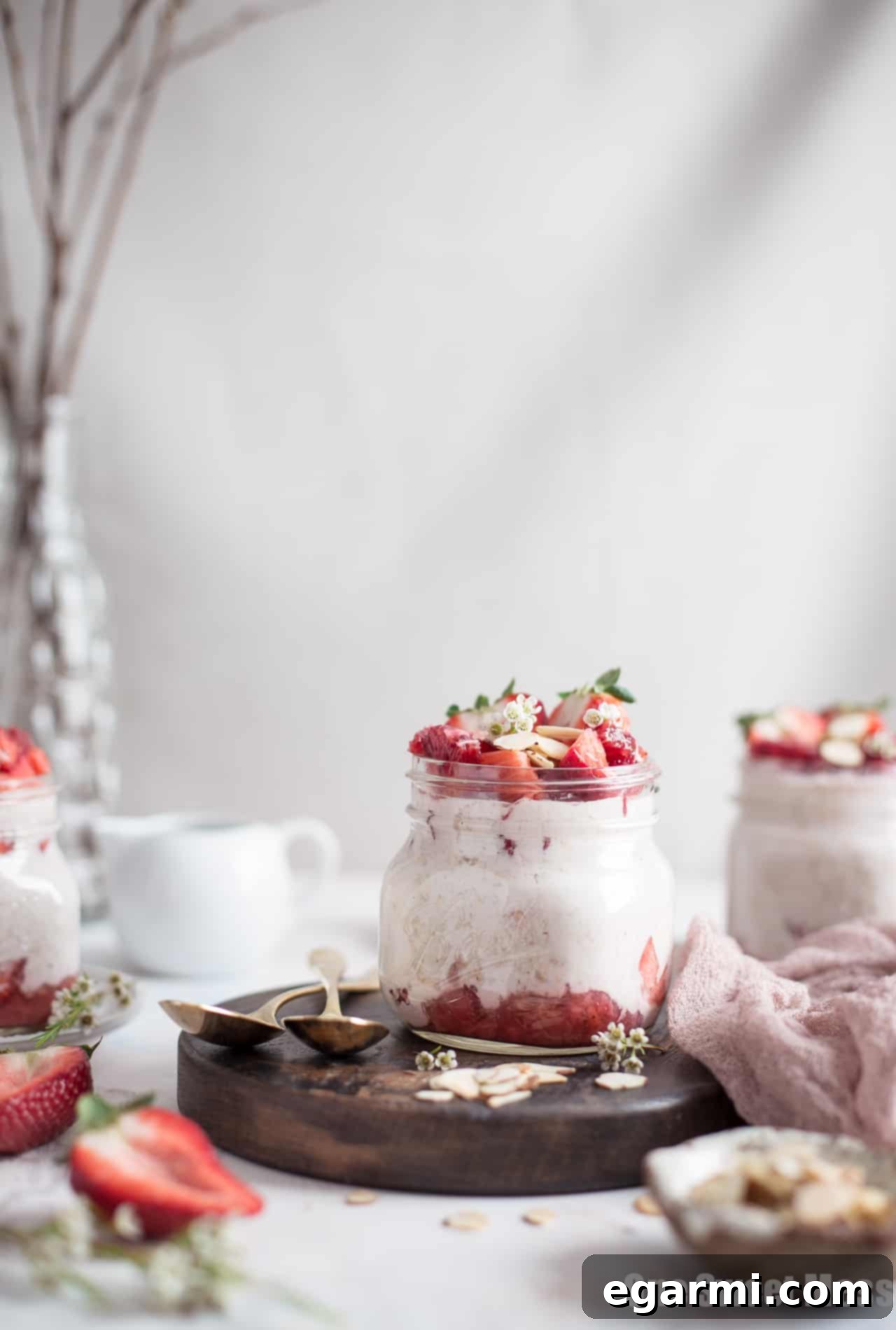 Seven jars of Strawberries and Cream Overnight Oatmeal, lined up and ready for the refrigerator.