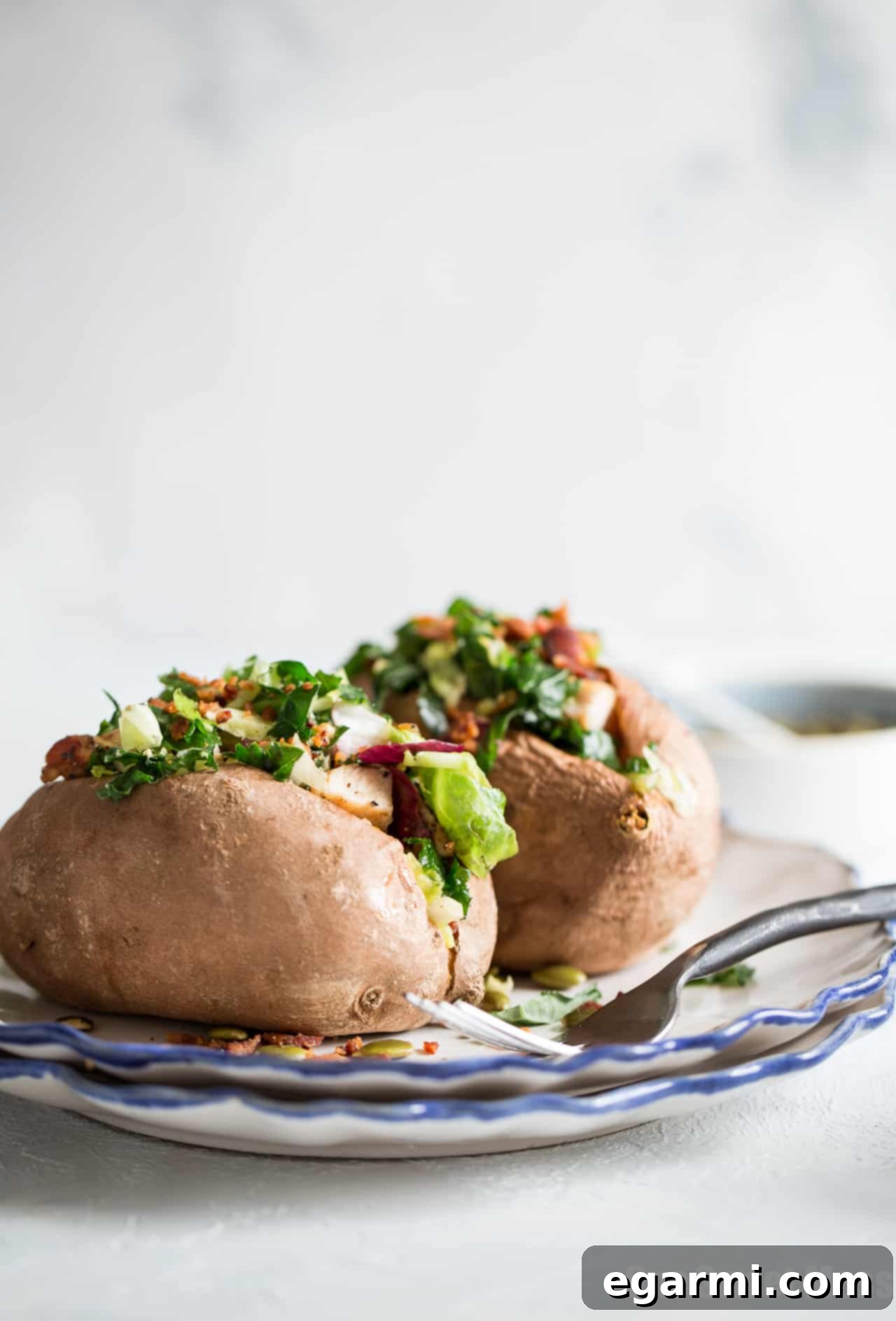 Delicious and easy stuffed sweet potatoes with grilled chicken and warm bacon vinaigrette kale salad.
