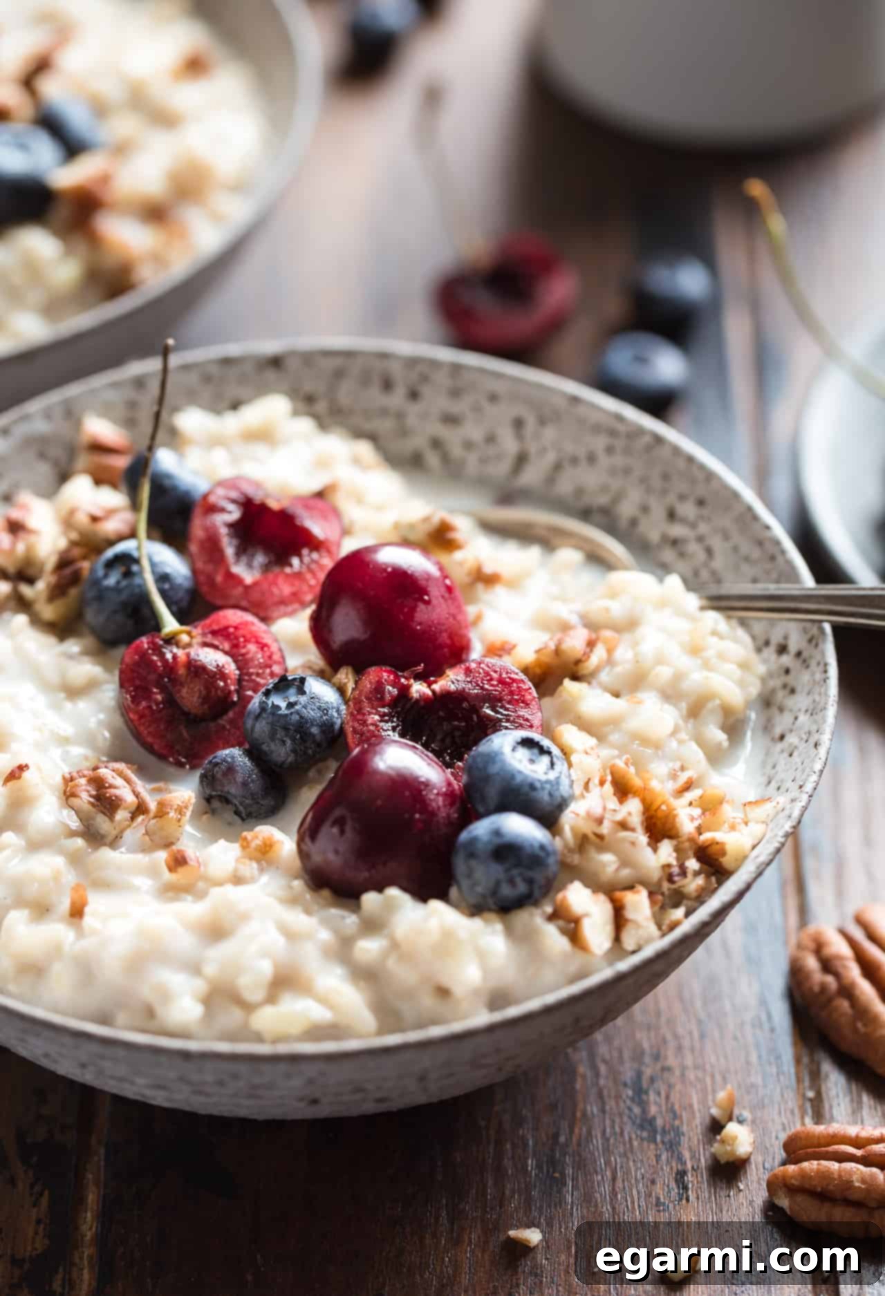 Close-up of Brown Rice Breakfast Pudding with fresh berries and nuts, highlighting its inviting texture